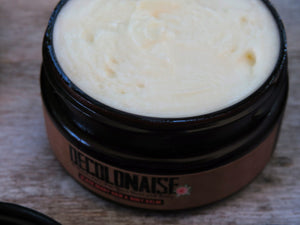 black berry hair and body balm in a jar with the lid open showing creamy texture